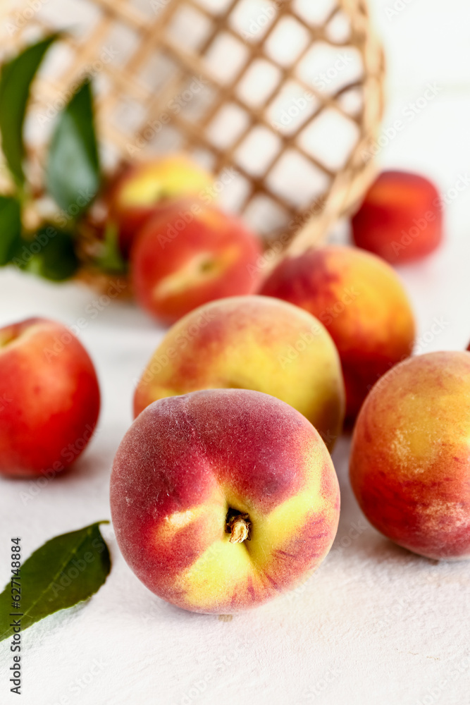 Many sweet peaches on white table