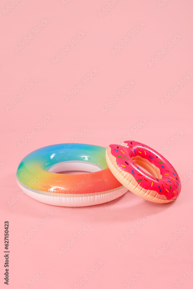 Inflatable rings on pink background