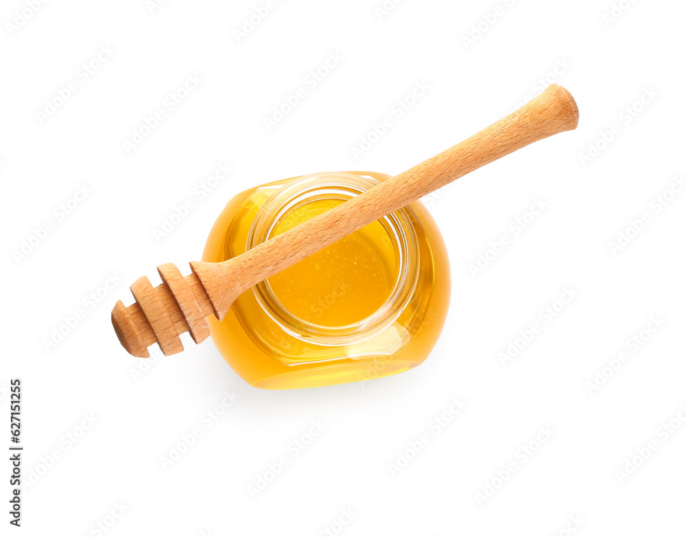 Jar of sweet honey and dipper on white background