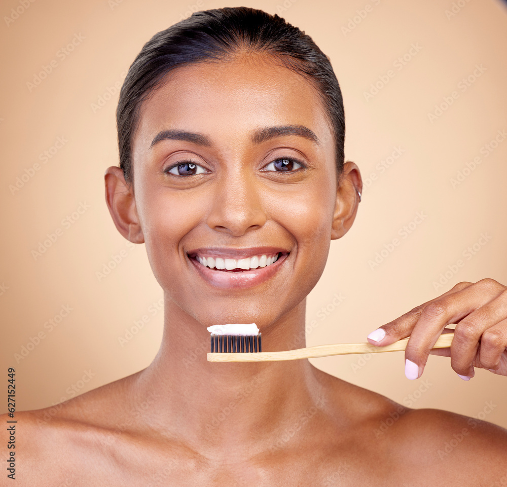 Woman, wood toothbrush and studio portrait for smile, cleaning and teeth whitening by brown backgrou