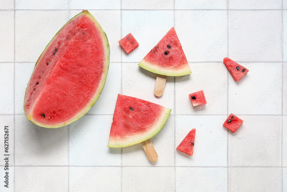 Composition with tasty watermelon sticks on light tile background