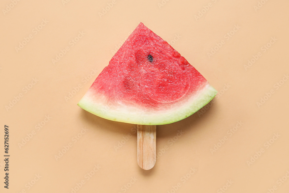 Tasty ripe watermelon stick on beige background