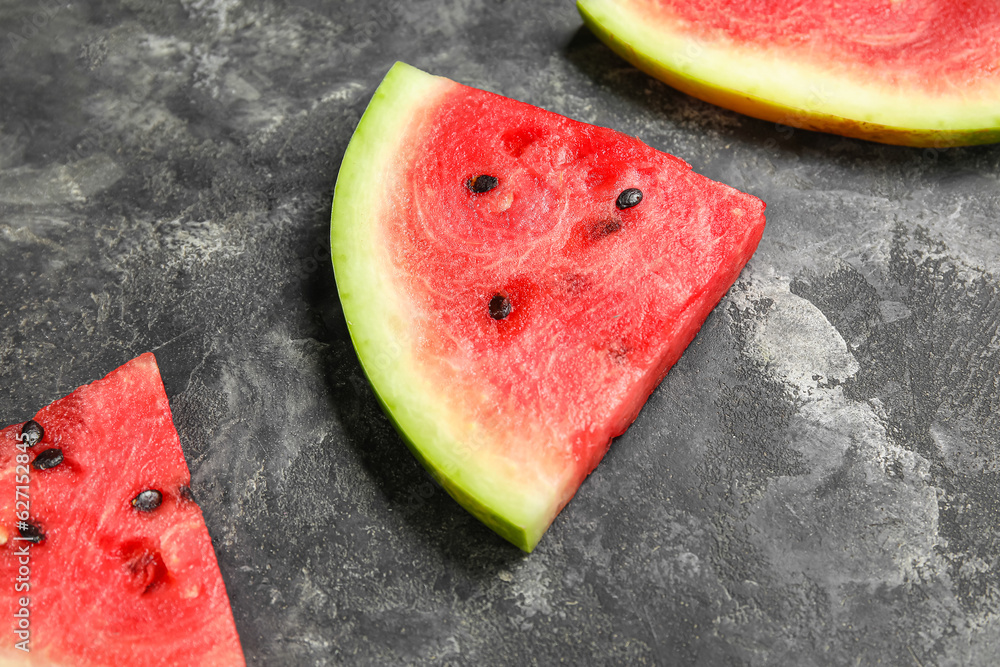 Pieces of fresh ripe watermelon on dark background, closeup