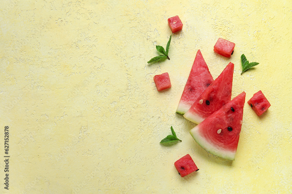 Composition with pieces of ripe watermelon and mint on yellow background