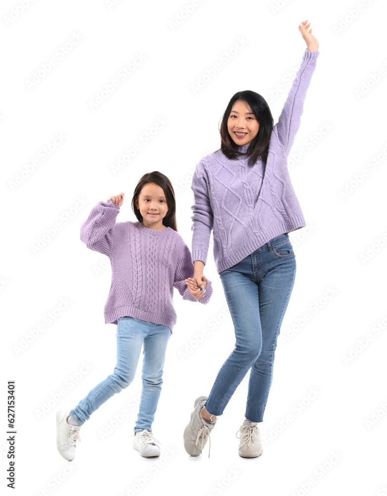 Asian mother with her little daughter holding hands on white background