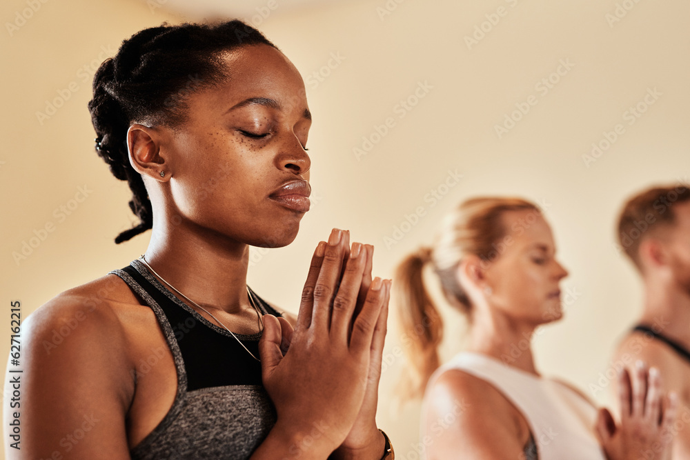 Talk to the universe through meditation. Shot of a group of young men and women meditating in a yoga