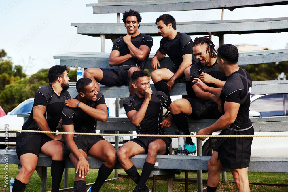 Action isnt just reserved for the field. Shot of a group of young men sitting on the benches togethe