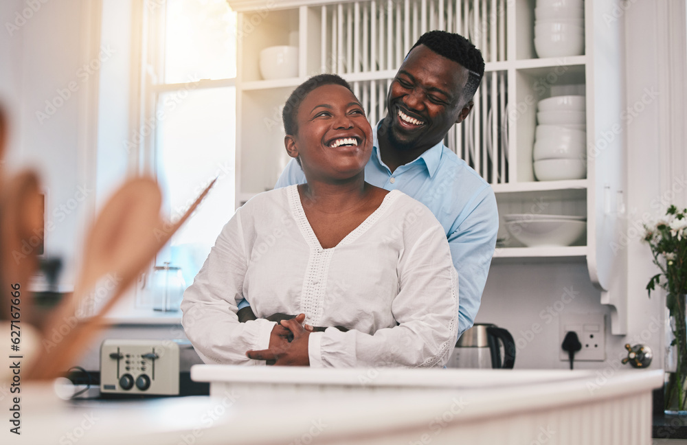 Hug, kitchen and happy black couple laugh, bond or enjoy quality time together, funny conversation o