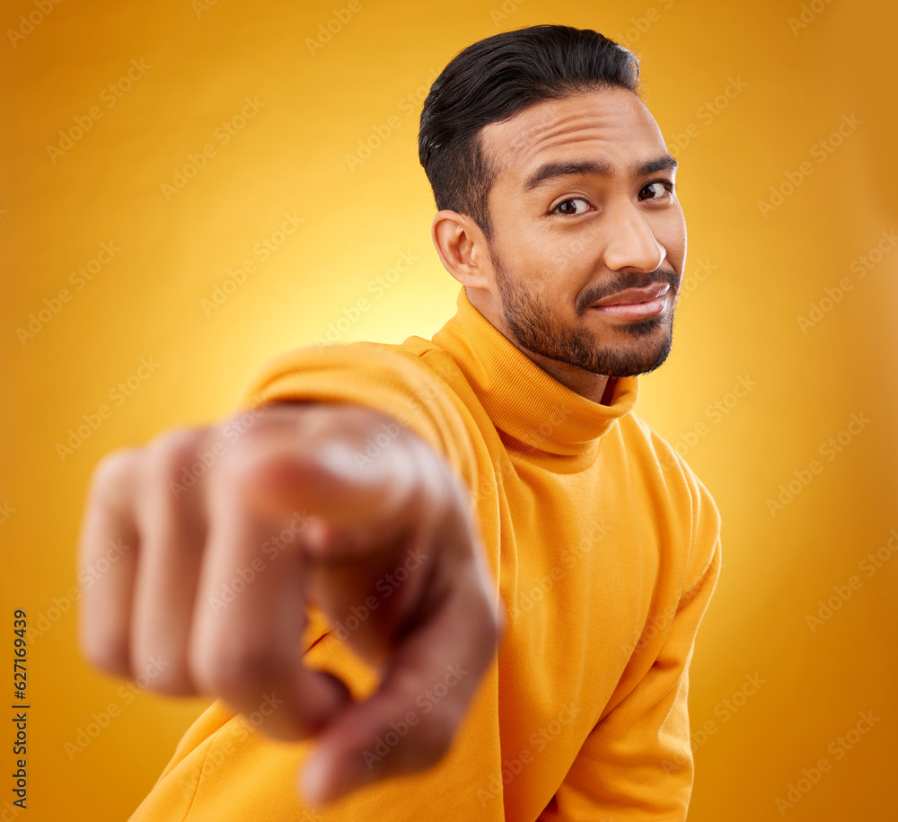 Portrait, asian man and hand pointing in studio with you, sign or thank you gesture on yellow backgr