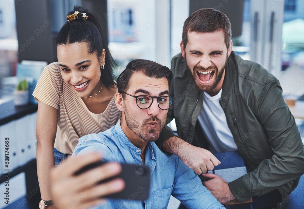 Never a dull moment when this dynamic team are together. Shot of a group of designers taking selfies