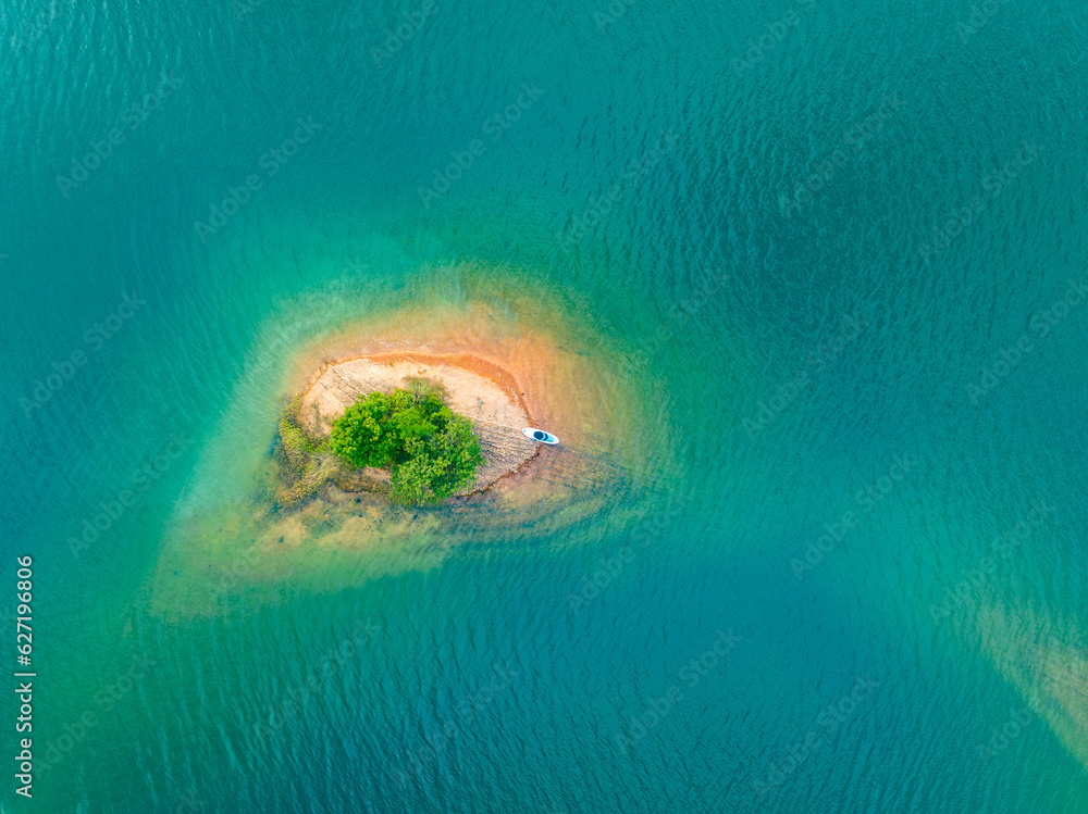 Overlooking the blue lake and islands, SUP board