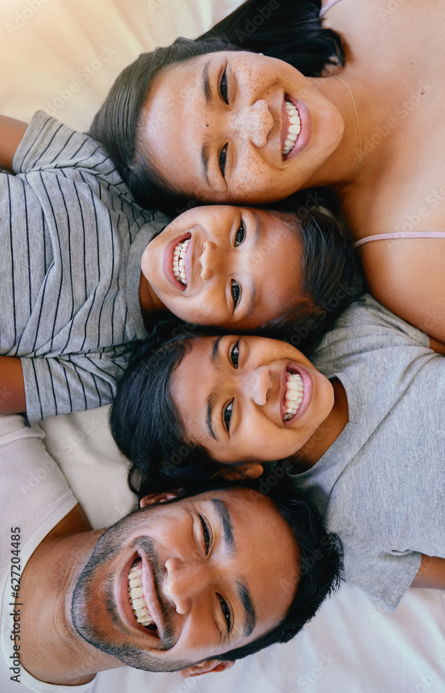 Portrait, smile and above asian family in bed, relax and having fun while bonding in their home. Top