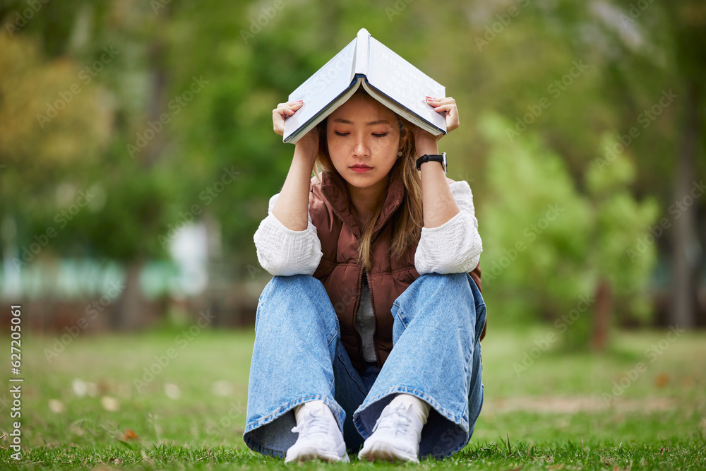 Study, stress and book with woman in park for studying, thinking and depression. College, mental hea