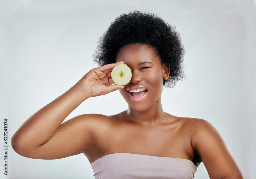 Happy black woman, portrait and apple for diet, natural nutrition or health against a white studio b