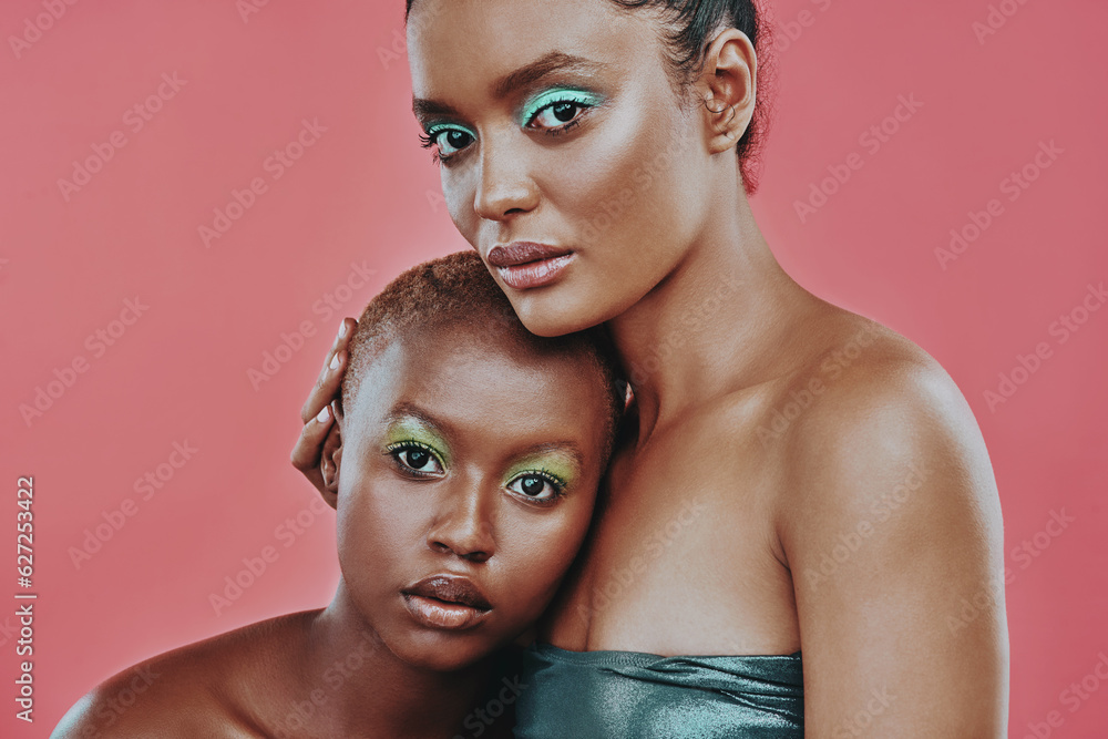 Woman friends, color makeup and art in studio portrait with beauty, cosmetics and hug by pink backgr