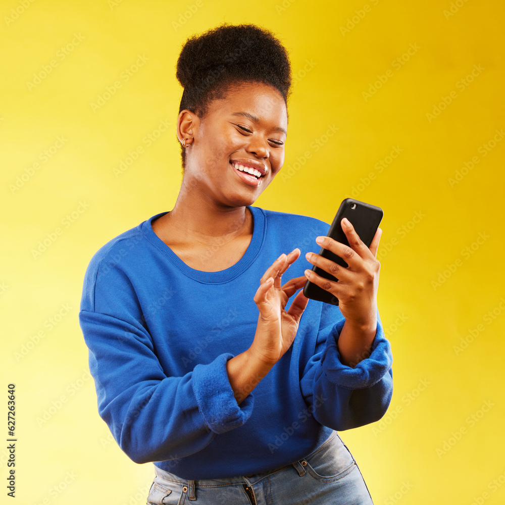 Happy black woman, phone and social media for networking or communication against a yellow studio ba