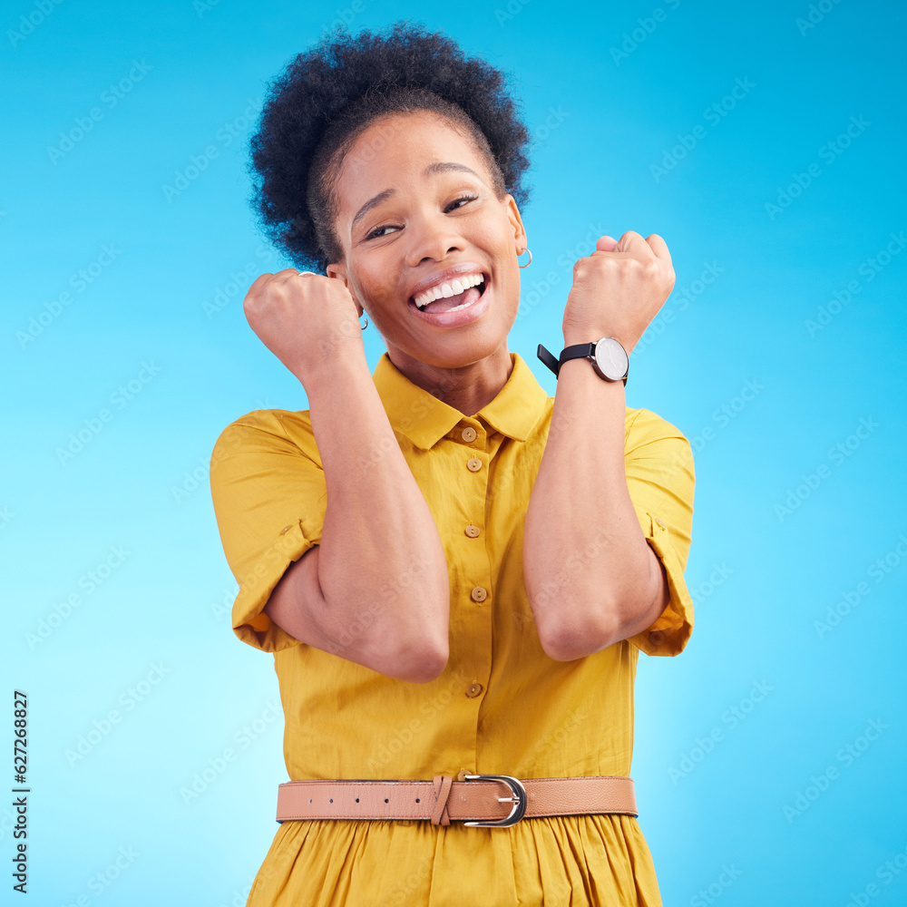 Celebration, fist and happy black woman in studio for news, deal or success on blue background. Wow,