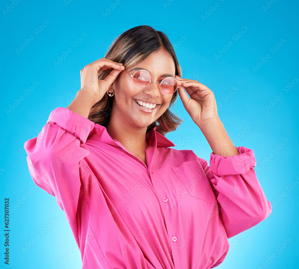 Fashion sunglasses, portrait and happy woman in studio isolated on a blue background. Face, glasses 