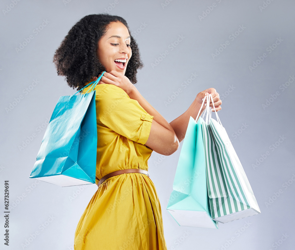 Excited, happy and woman with shopping bag for fashion in studio isolated on a white background. Smi