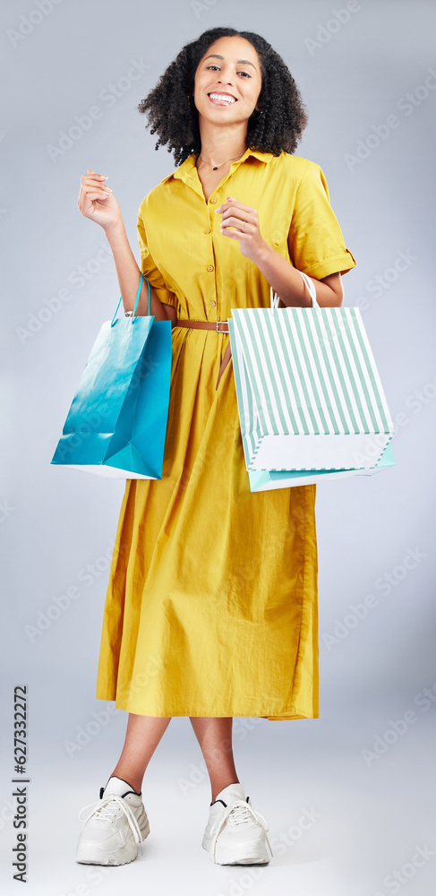 Portrait, shopping bag and a woman in studio for fashion sale, promotion or retail discount. African