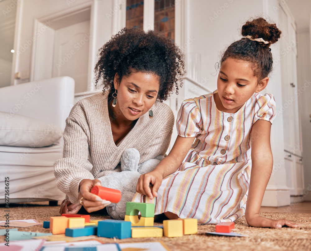 Family, education and building blocks with a daughter learning from her mother on the floor of their