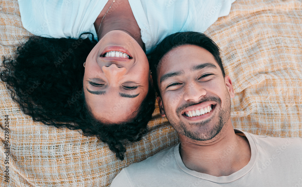 Portrait, picnic and smile with a couple on a blanket from above, lying down on the ground while on 