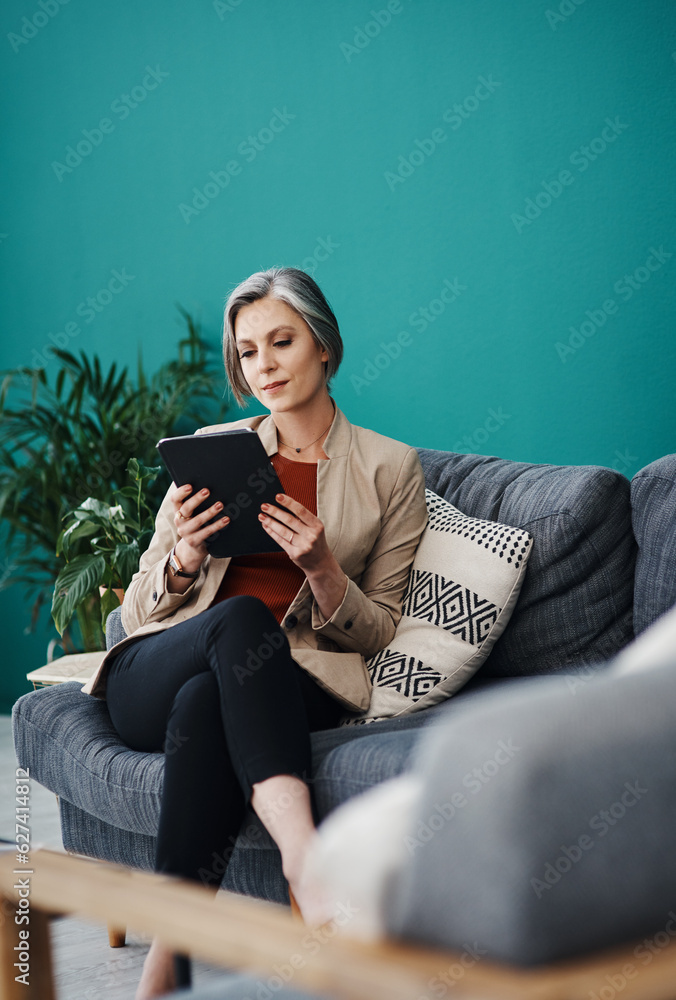 Analysing the data correctly. Cropped shot of an attractive mature businesswoman sitting alone and u