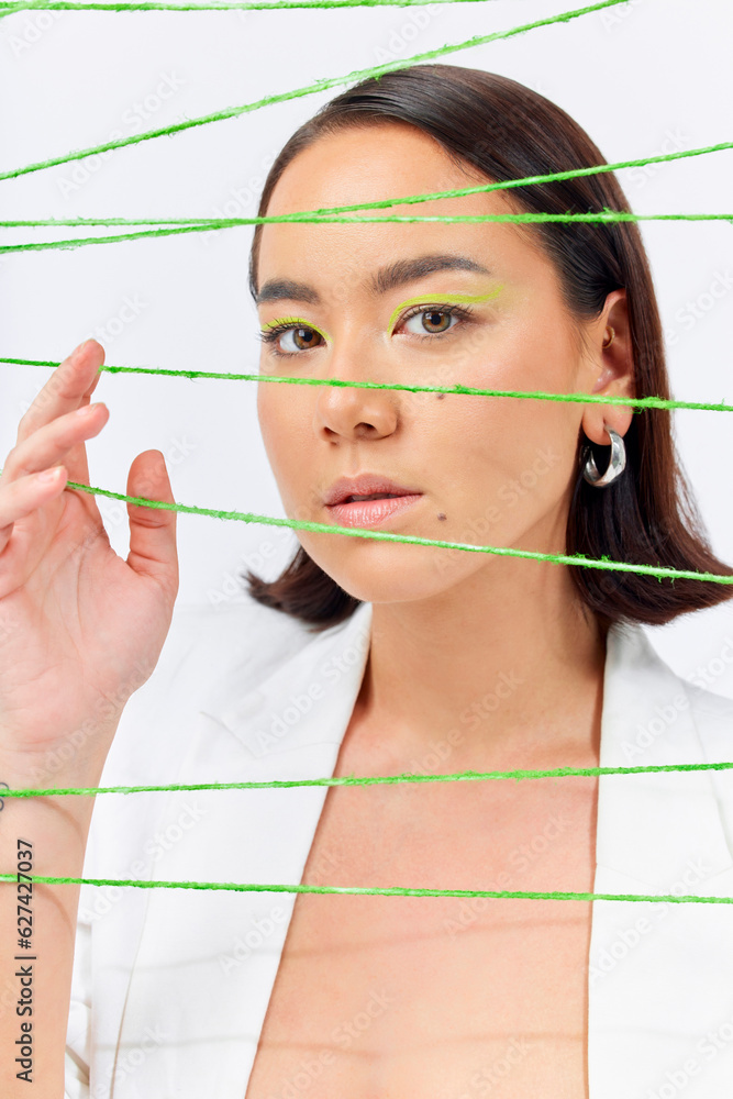 Creative, fashion and string with portrait of woman in studio for makeup, art and cosmetics. Abstrac