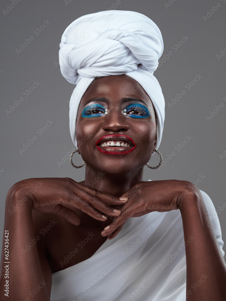 Shes a true African queen. Studio shot of an attractive young woman posing in traditional African at