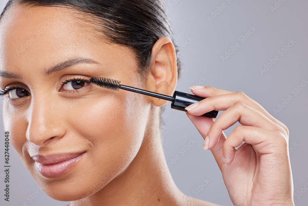 Portrait, mascara and woman with brush in studio for makeup, cosmetics and results on grey backgroun