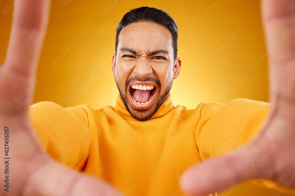 Shouting, portrait and selfie of angry man in studio isolated on a yellow background. Face, screamin