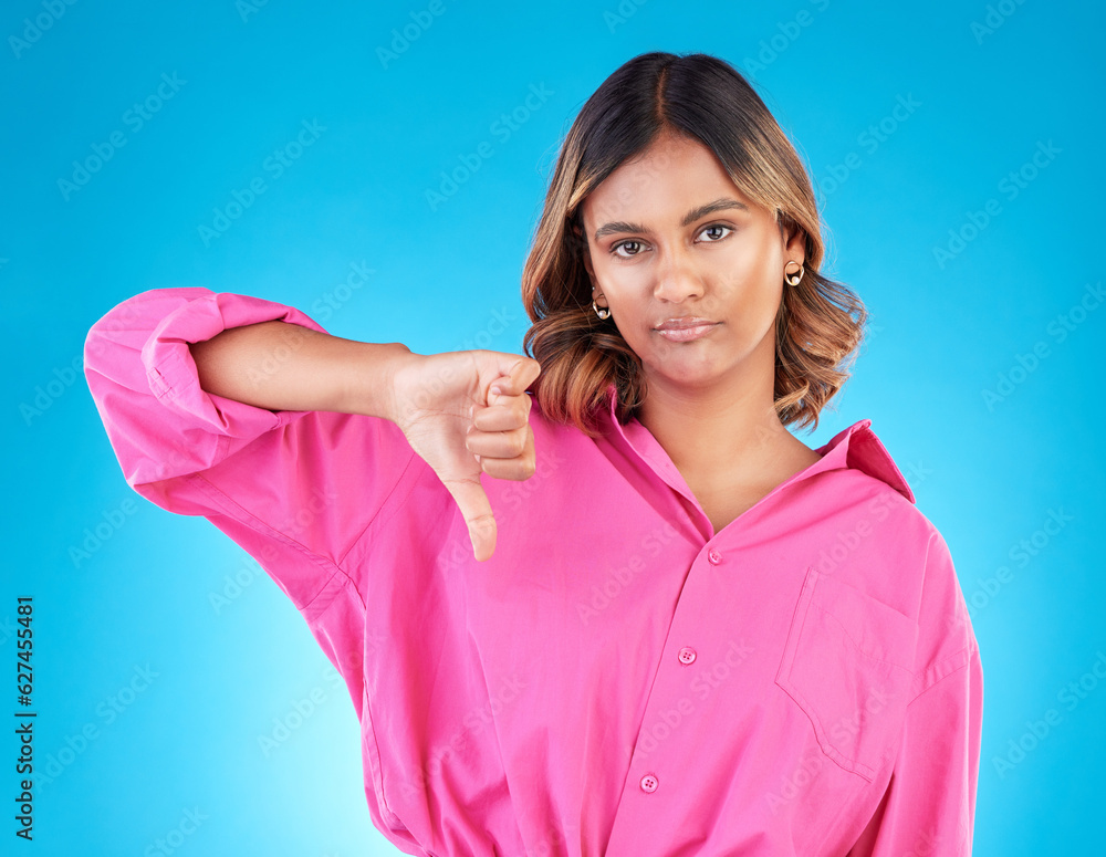 Thumbs down, bored and portrait of a woman in a studio with a disagreement or negative expression. U