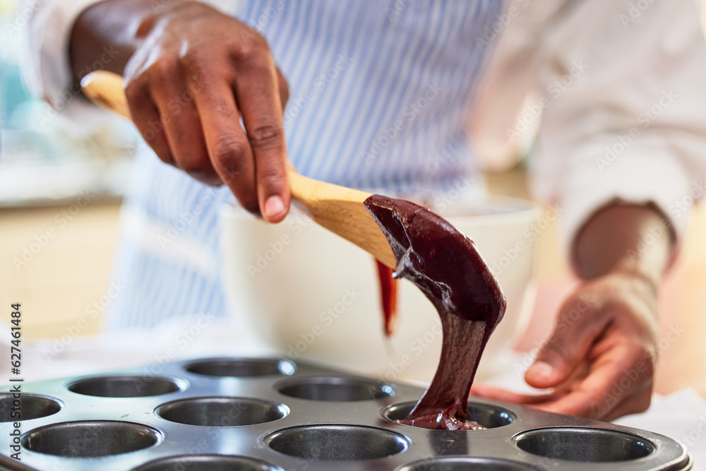 Cupcake, chocolate and hands of a person baking in a kitchen and cooking dessert recipe in the morni