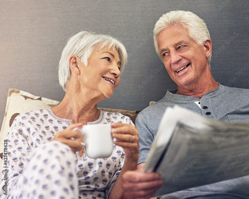 Coffee, newspaper and a mature couple in bed, enjoying retirement in their home in the morning. Tea,