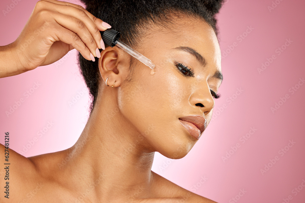 Black woman, oil and serum on face, skincare shine or aesthetic dermatology on pink background in st