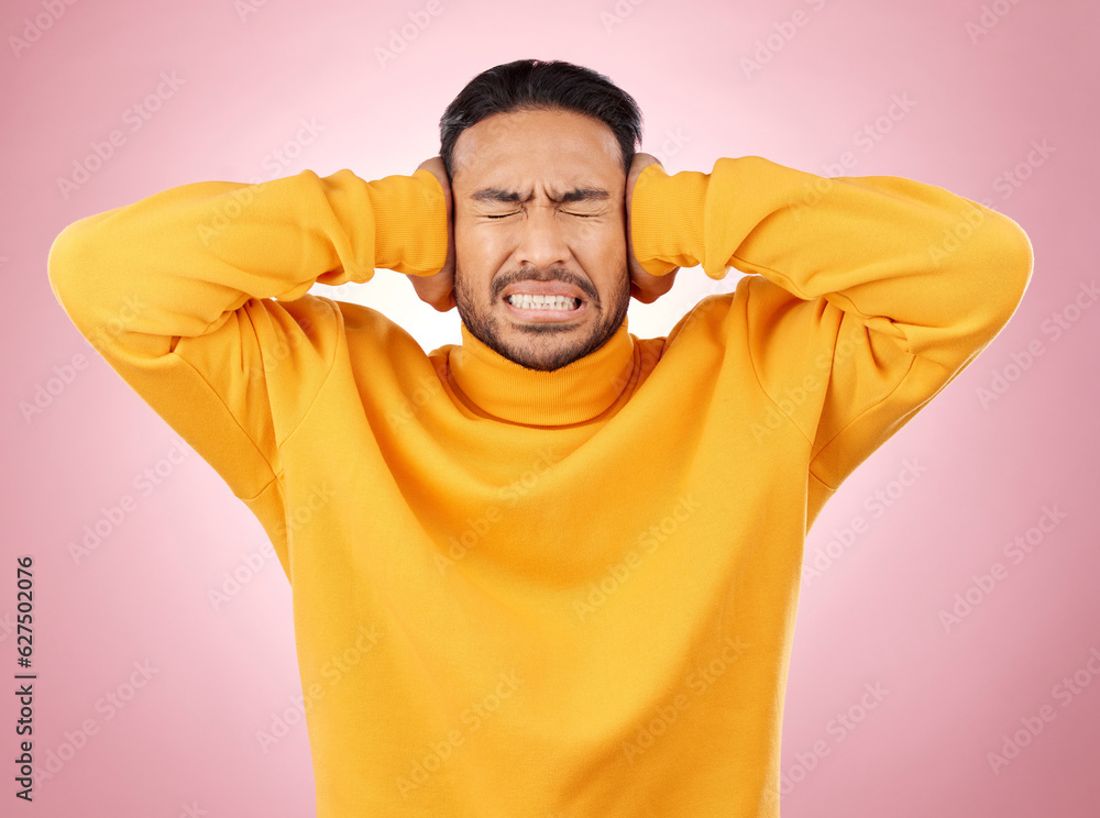 Man, headache and cover ears for stress or mental health of student frustrated on a pink background.