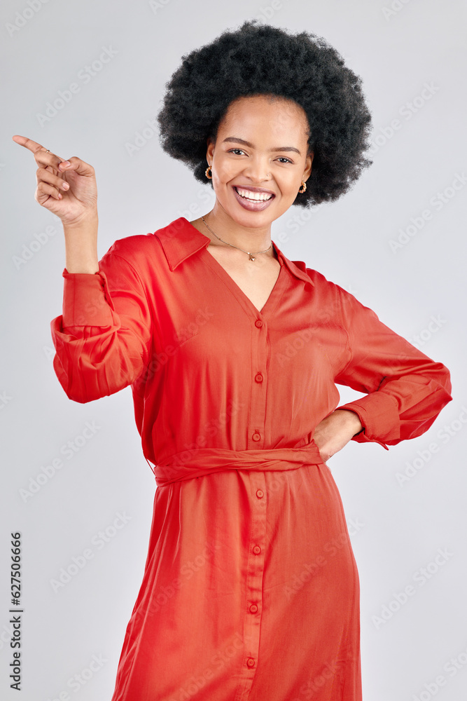 Pointing, portrait and black woman with a smile, promotion and presentation against a white studio b