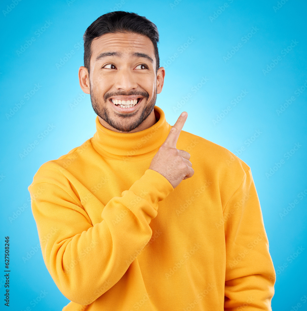 Asian man, smile and hand pointing to studio for news, deal and discount or how to guide on blue bac