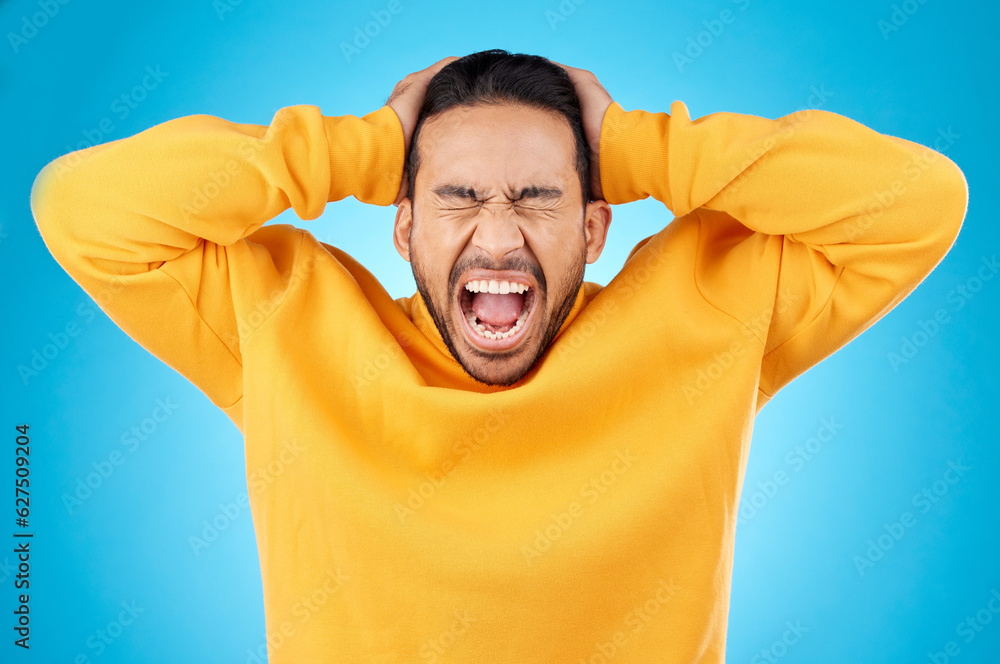 Angry, man and face with screaming in studio with burnout, anxiety and stress. Isolated, blue backgr