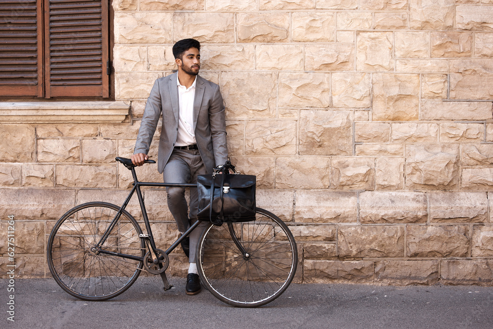 Bicycle, suit and businessman in the city for travel standing by a brick wall building. Briefcase, p