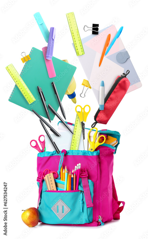 School backpack with stationery and apple on white background