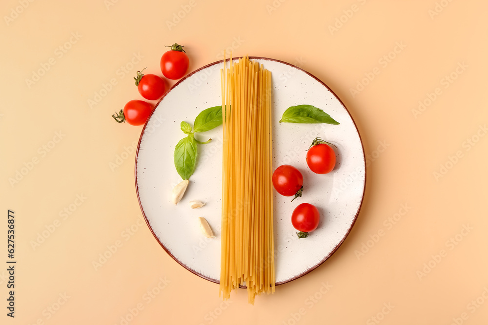 Plate with raw pasta and ingredients for pesto sauce on light background