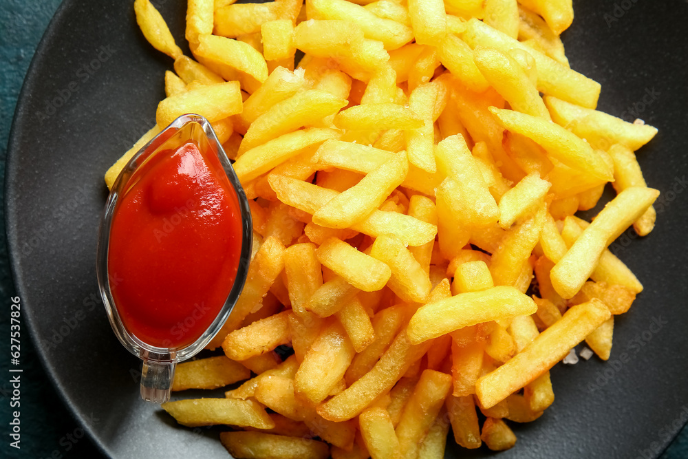 Plate with tasty french fries and ketchup, closeup