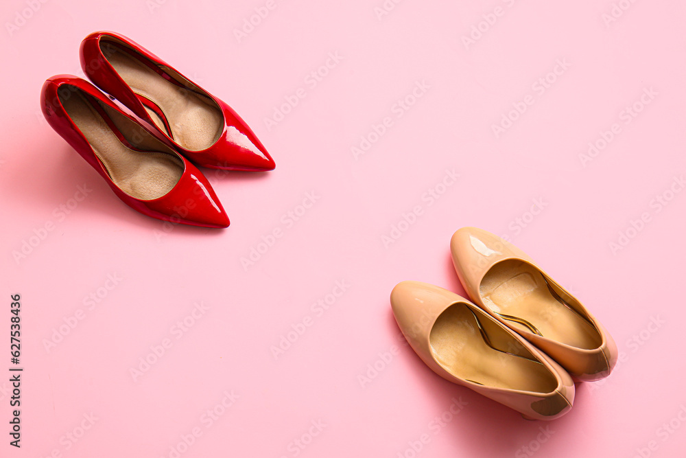 Fashionable high heeled shoes on pink background