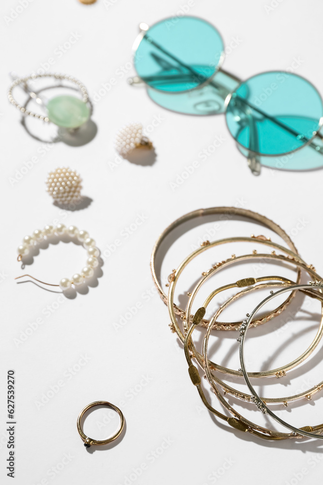 Jewelry with sunglasses on white background, closeup