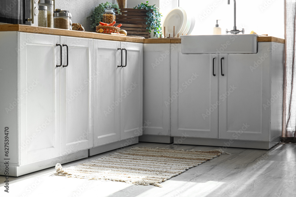 Stylish rug on floor in modern kitchen