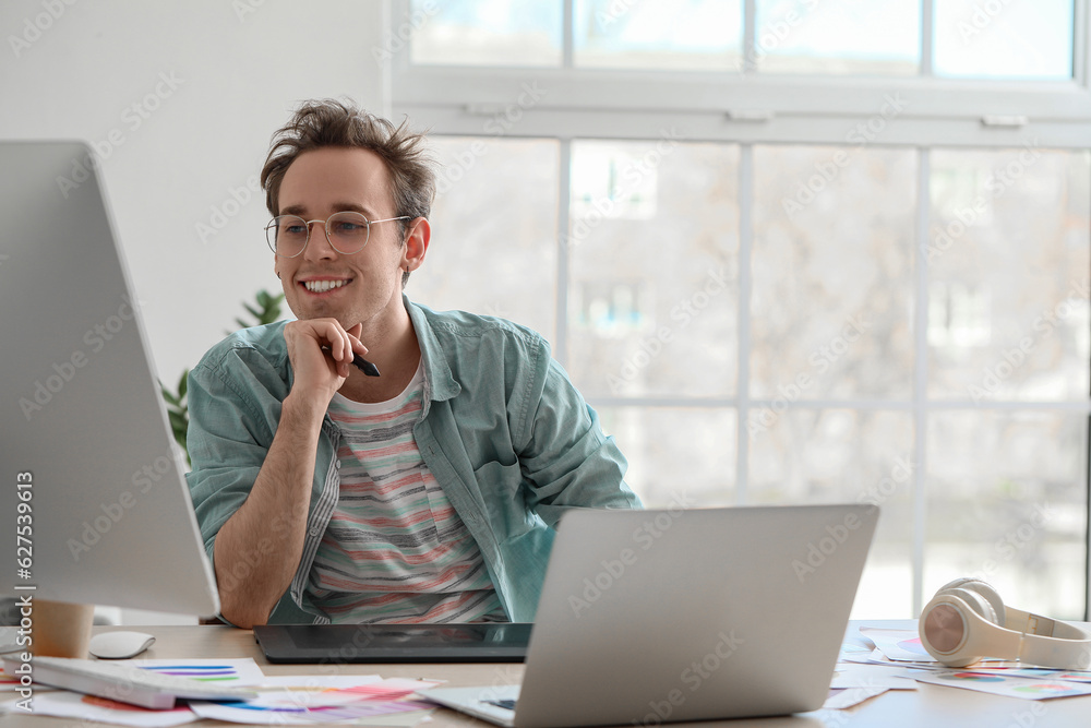 Male graphic designer working in office