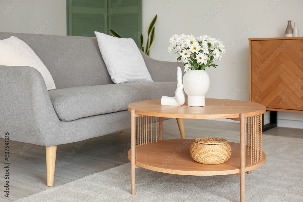 Interior of living room with grey sofa and coffee table