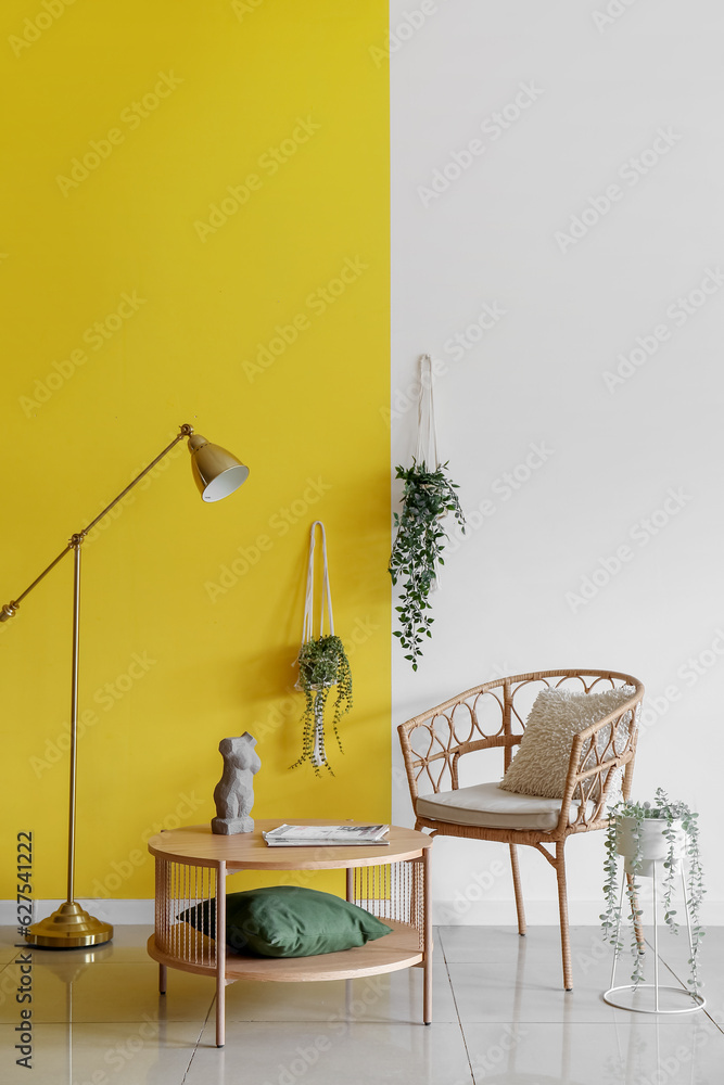 Simple interior of living room with armchair, coffee table and hanging houseplants