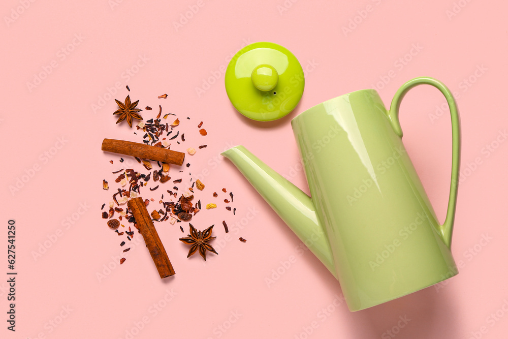 Ceramic teapot with spices on pink background